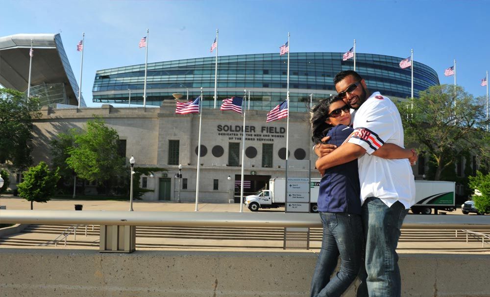 Couple embracing outside a stadium