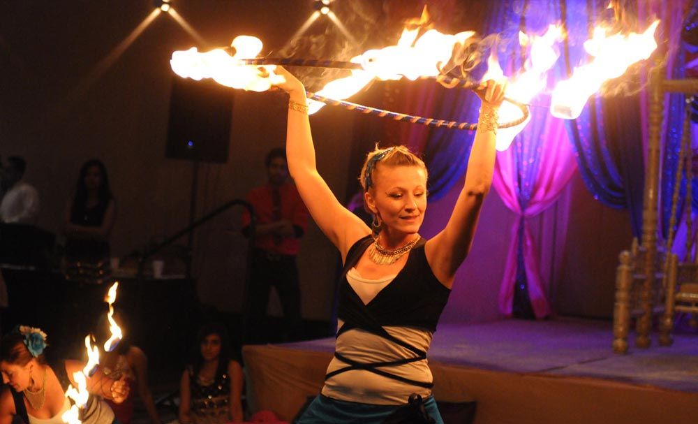 Wedding guest dancing beneath colorful lights