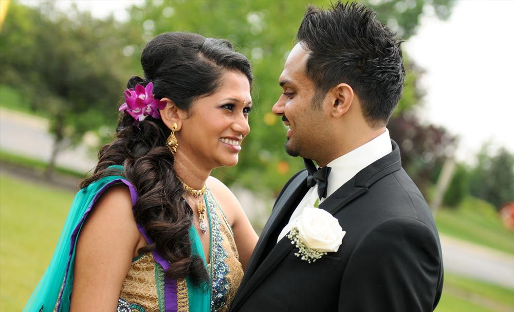 Smiling bride and groom in a close outdoor portrait