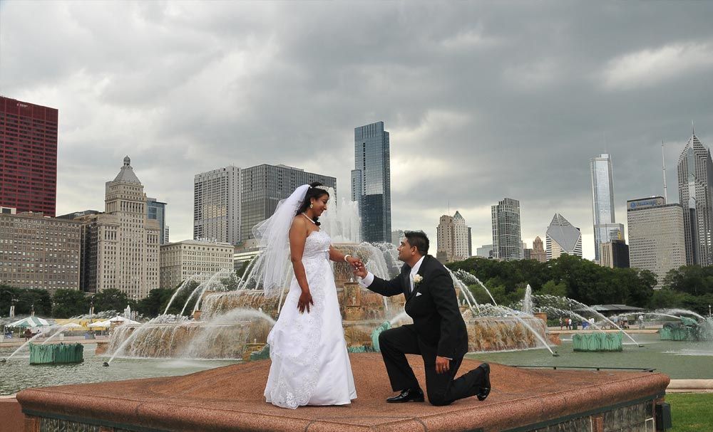 Bride and groom posing with a city skyline