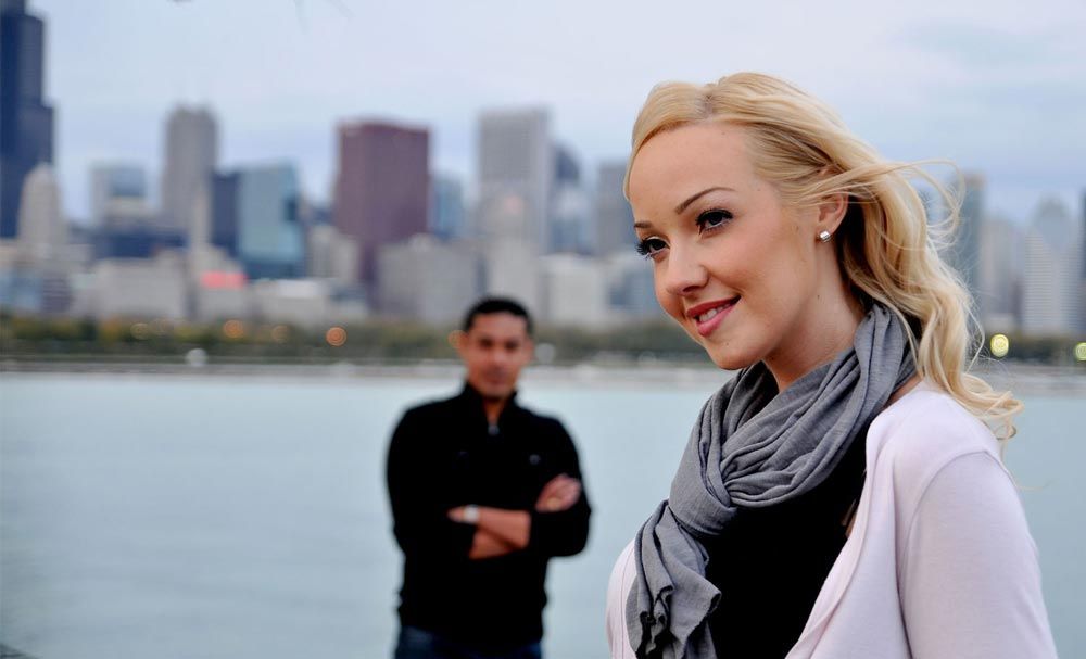 Engaged couple photographed by the waterfront