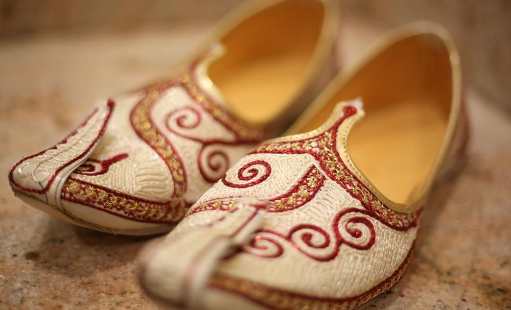 Embroidered wedding shoes photographed in close detail