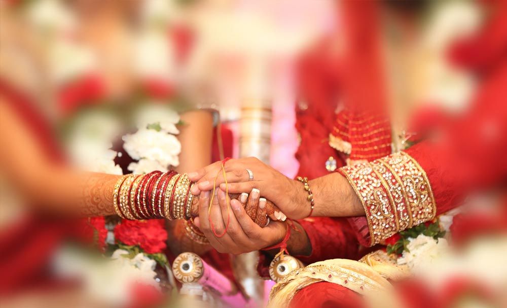 Bride and groom holding hands during the ceremony