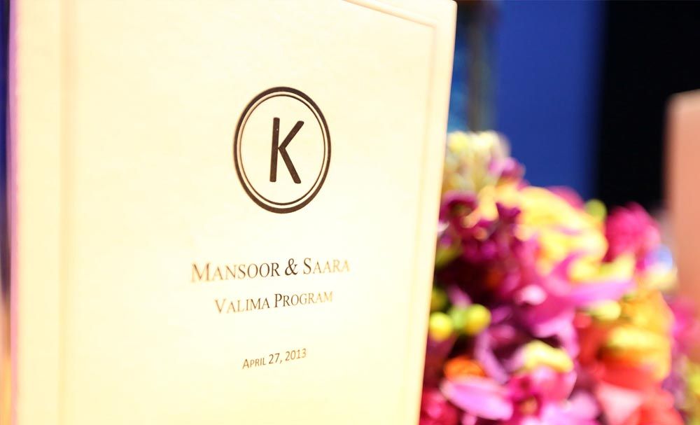 Wedding program beside colorful flowers