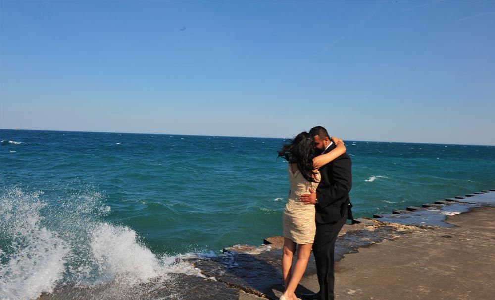 Couple embracing beside the water